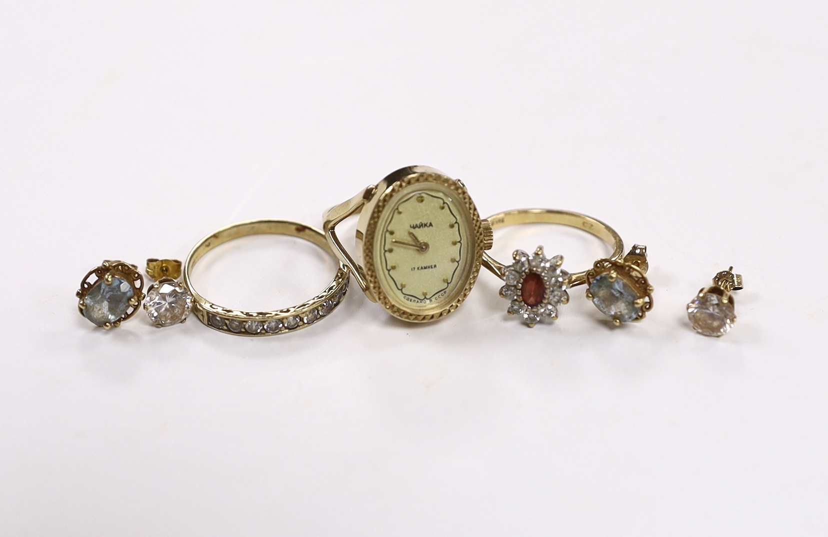 A modern 9ct and CZ set cluster ring, two other rings including watch ring and two pairs of 9ct ear studs.